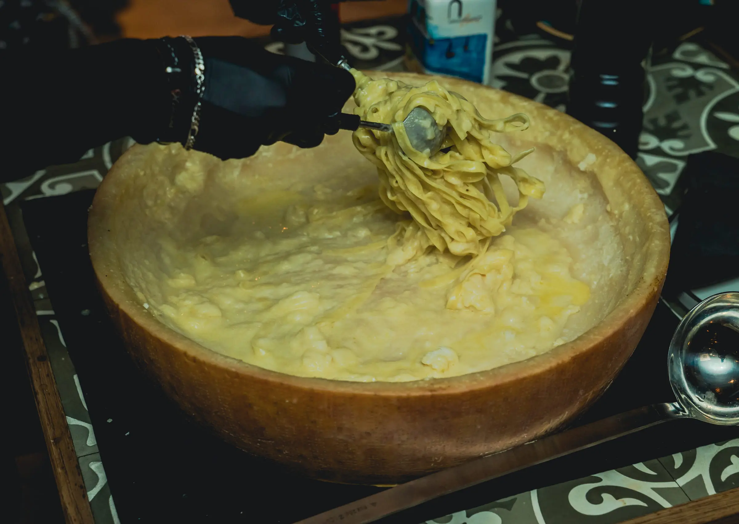 Fresh pasta tossed inside a wheel of Parmigiano