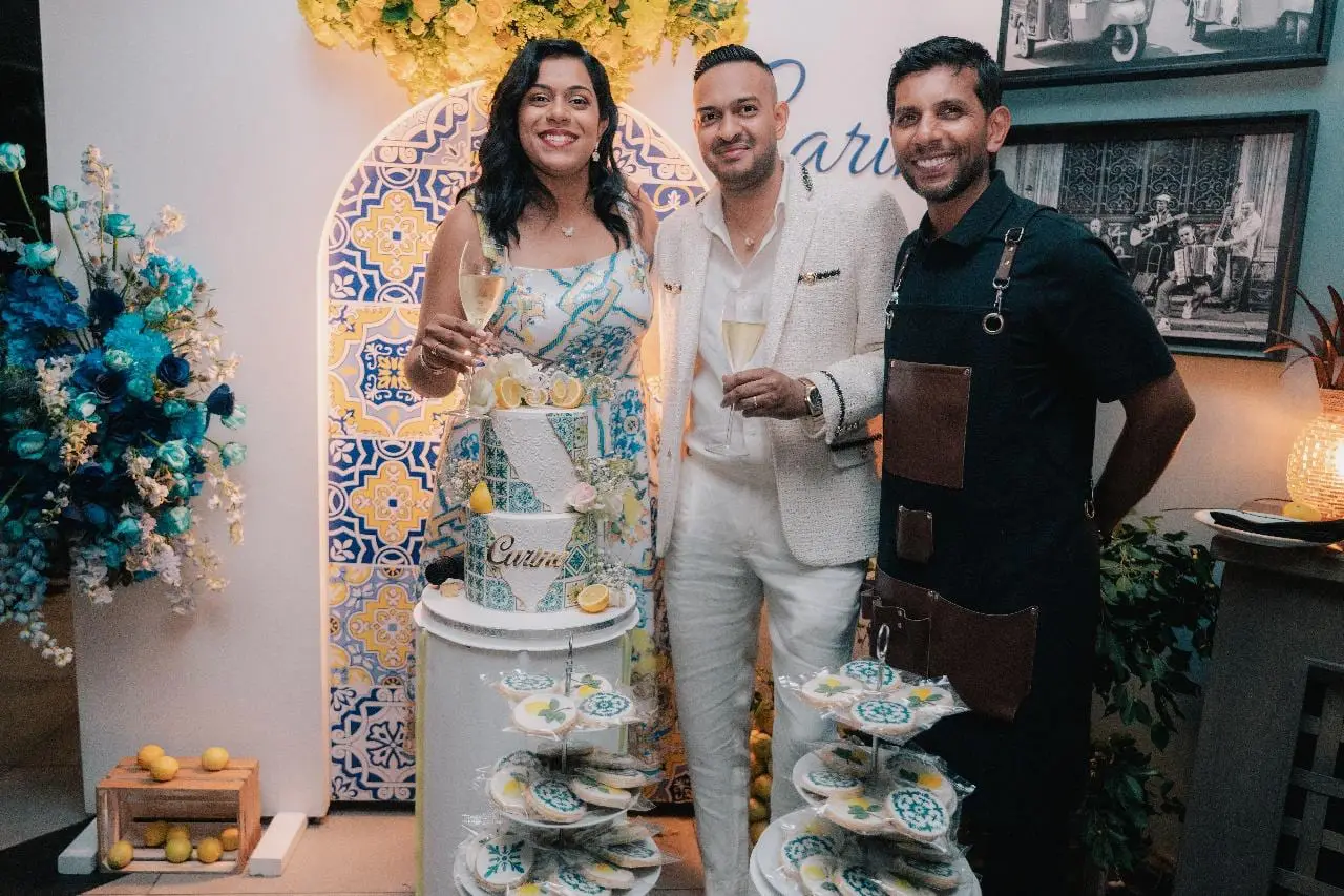A lemon-themed Amalfi celebration cake with the hosts