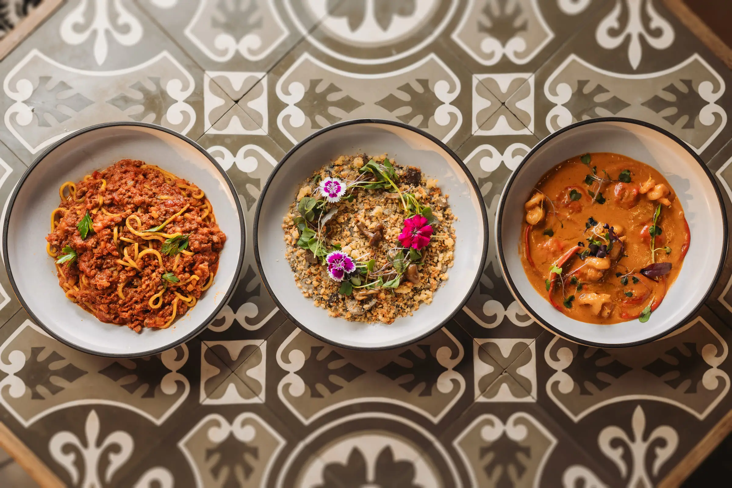 Pasta and risotto plated over Botteghita&rsquo;s patterned floor tiles