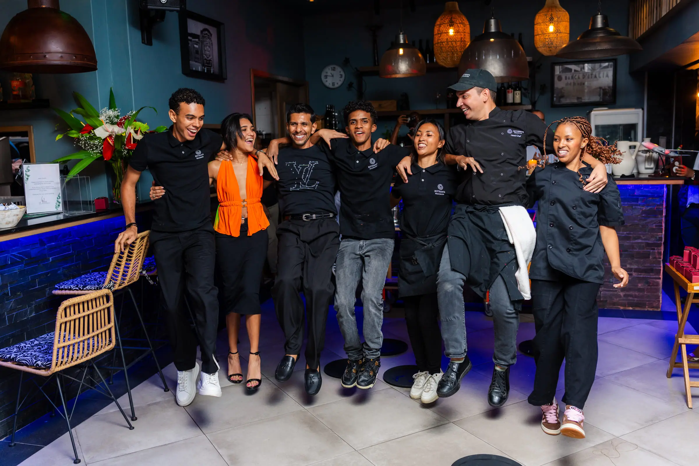 The Botteghita team mid-jump in the dining room